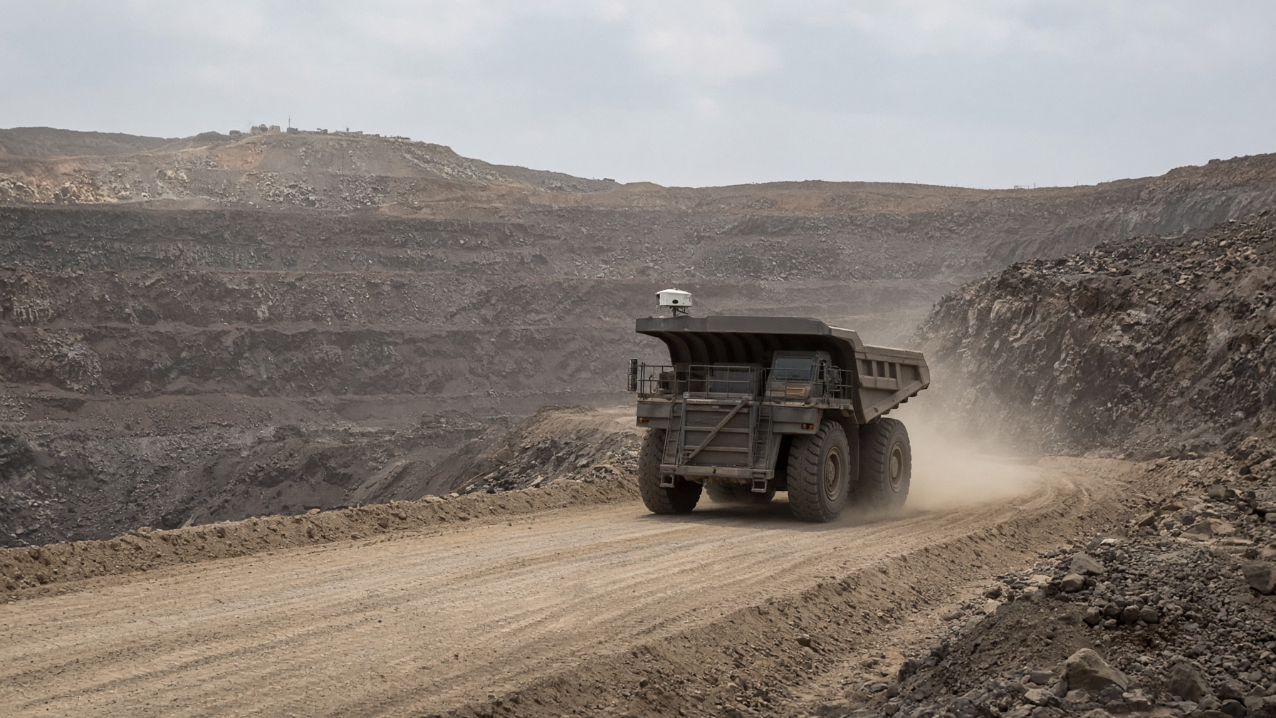 A haul truck on a road in an open-pit mine.