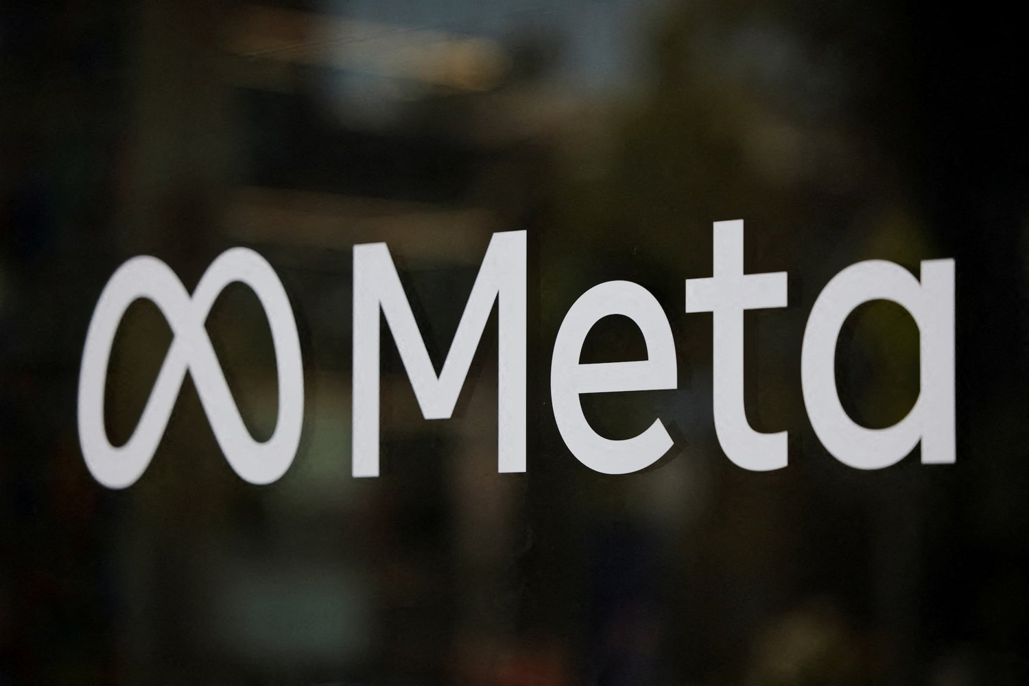 The Meta name and infinity mark on glass.