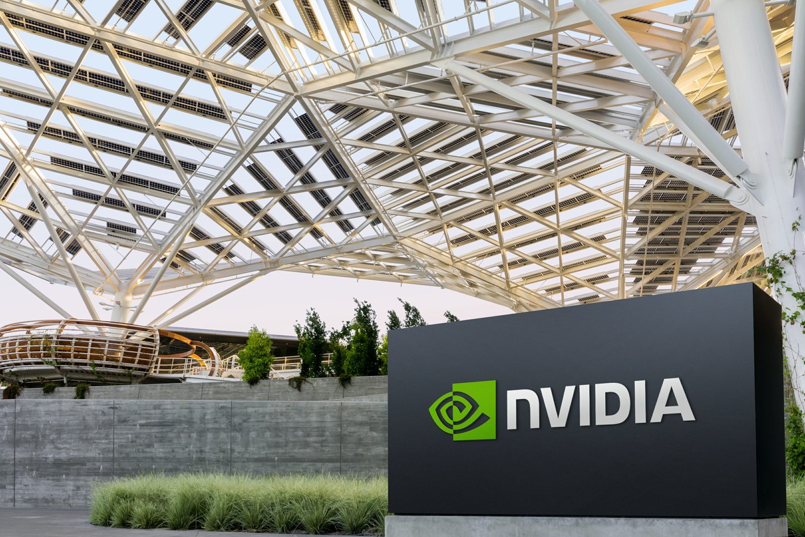 An NVIDIA sign outside a building with a solar canopy.